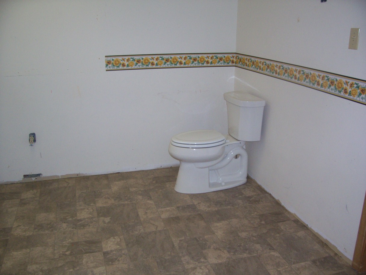 Flooring and toilet in family washroom.