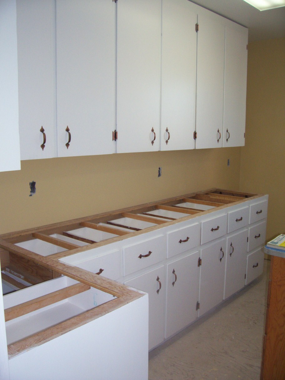 Kitchen cabinets painted and the hinges and handles put on.